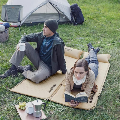 Inflatable camping mattress with built-in pillow